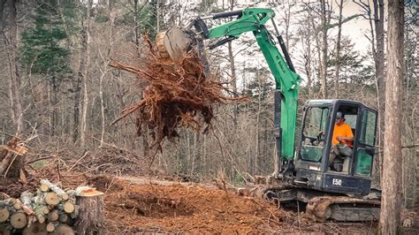 pulling up tree stumps with a mini excavator|how to remove tree stumps.